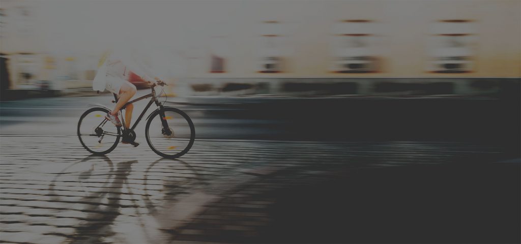 A dark background imge of a cyclist on the road