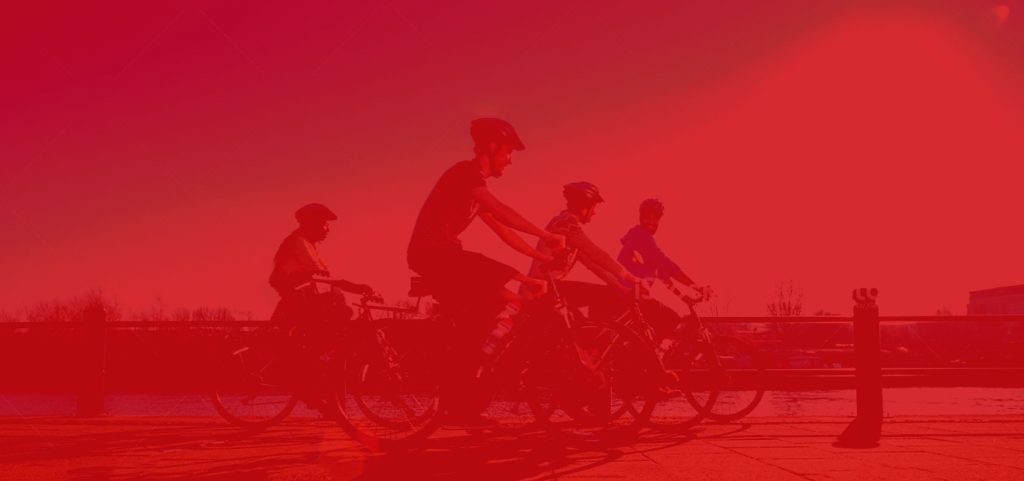 A red background image of cyclists on the street