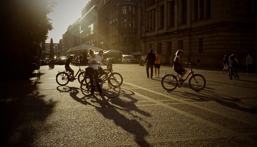 A group of cyclists in the summer, in the city.
