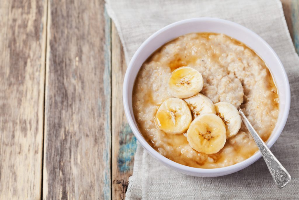 Healthy breakfast, oatmeal porridge with banana.