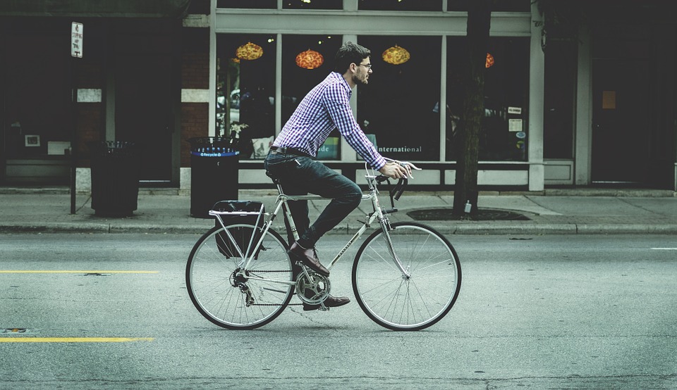 A cyclist in casual businesswear.