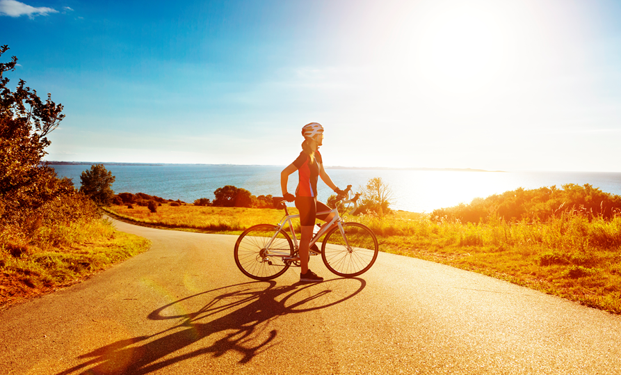 A cyclist taking a moment to take in a beautiful view.