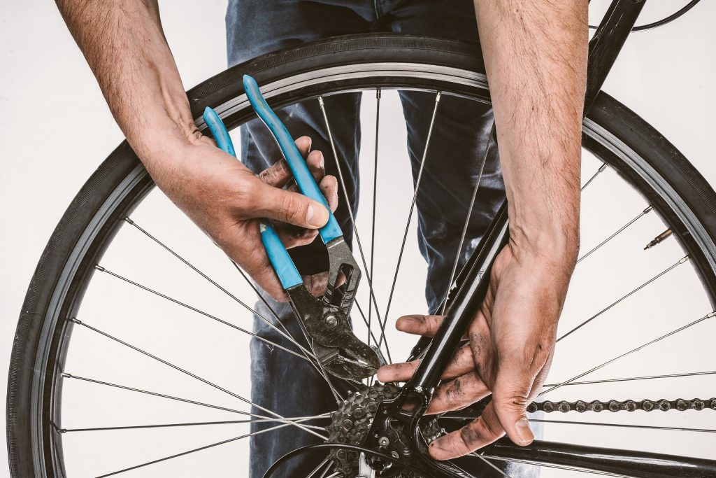 A man repairing his bike.