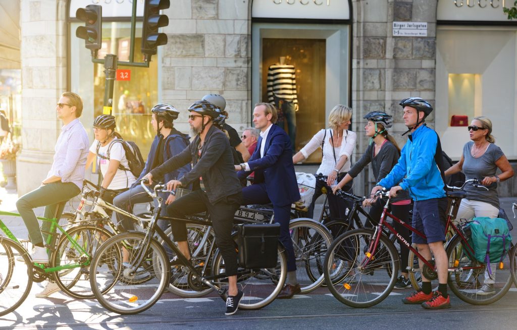A group of cyclists waiting at a light.