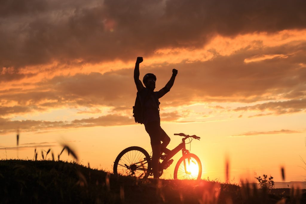 A cyclist raising his arms.