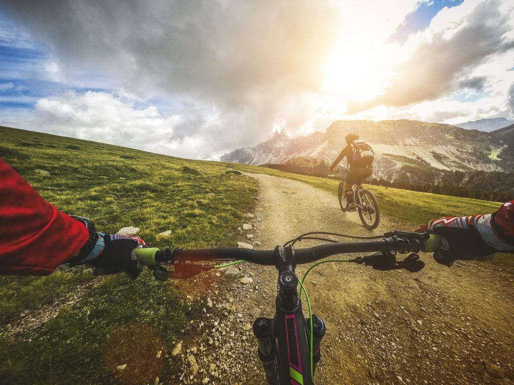 Riding a mountain bike on the Alps: point of view camera filming.