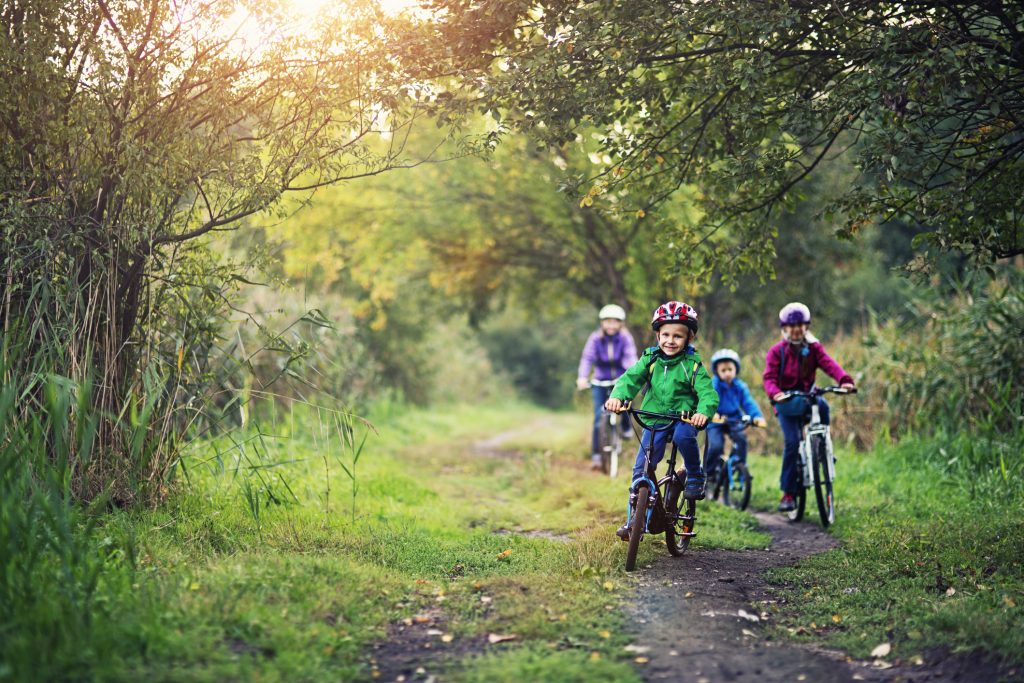 Family riding bicycles in beautiful nature.