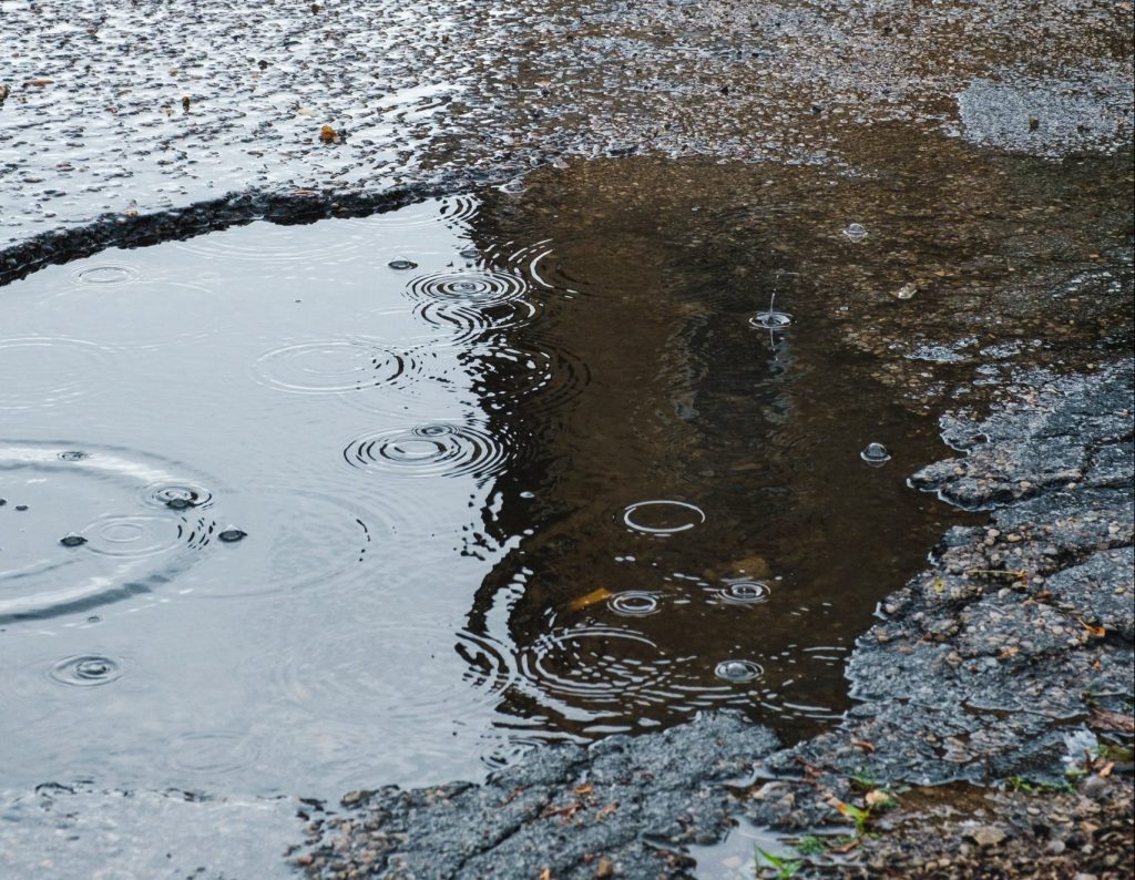 A large pothole in a road.