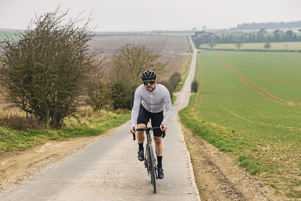 Cyclist on road in countryside.