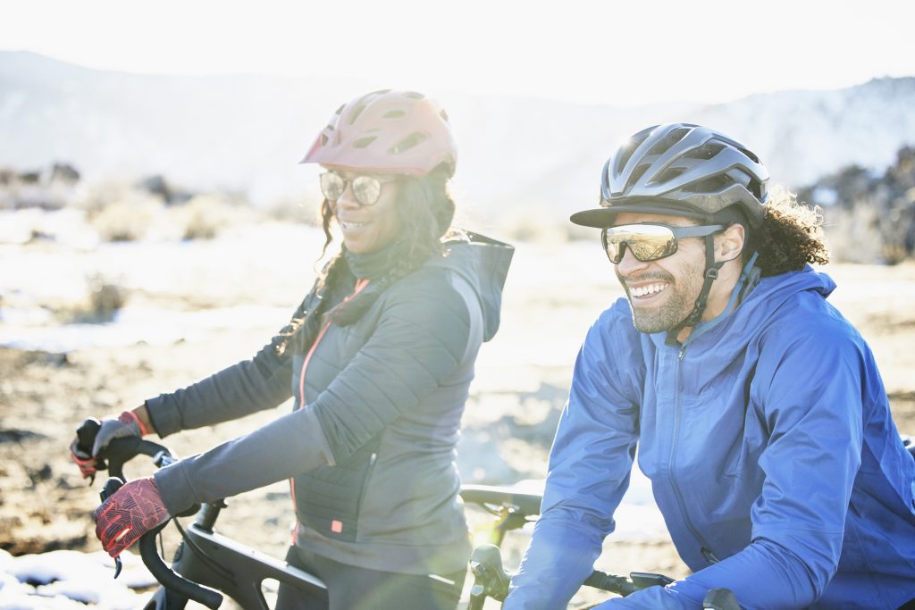 Two cyclists smiling.