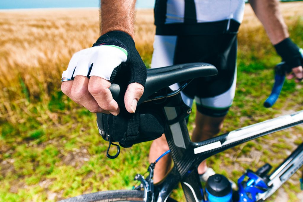 a cyclist holding his bike seat