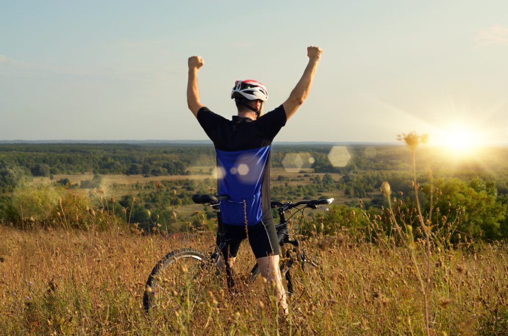 cyclist raising his arms