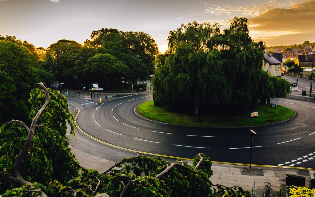 roundabout in England with trees in the center