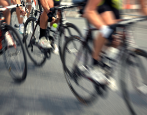 Several cyclists travelling at speed as part of a race.